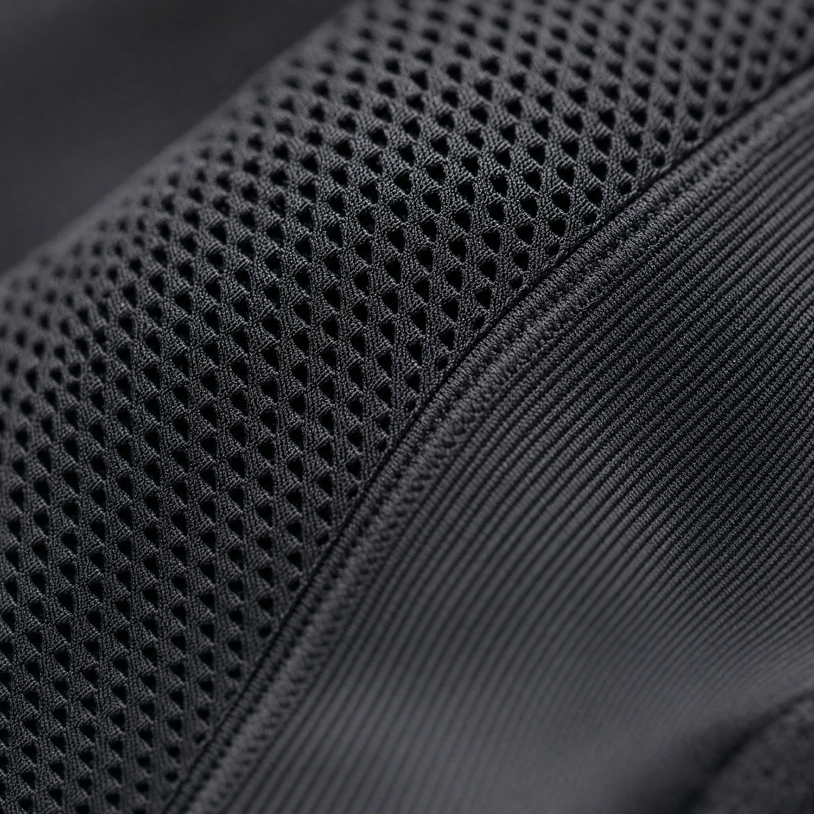 Close up of black compression knit with a mesh zone